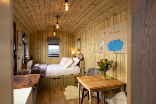 a small room with a bed and a table at Valentine in Longdown