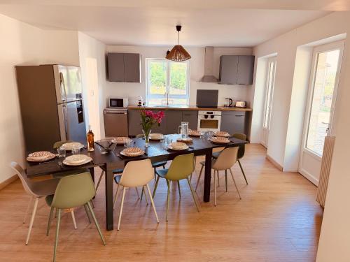 a kitchen with a table and chairs in a room at Gîte La Chaumière avec Piscine in Nailhac