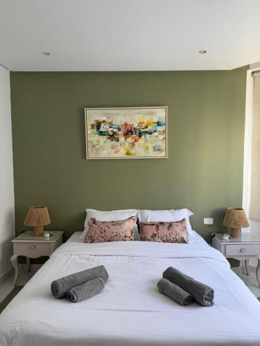 a bedroom with a bed with two pillows on it at Perle Verte de Gammarth in Tunis