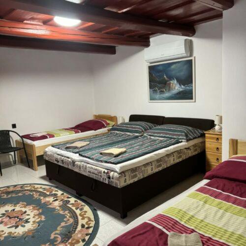 a bedroom with two beds in a room at Biró Vendégház in Sármellék