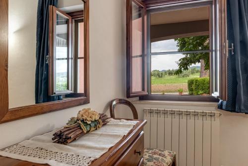 a room with a table with a window and a radiator at Capracotta in Montemassi