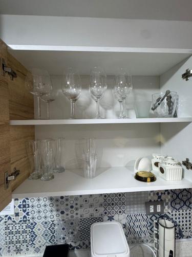 a kitchen with wine glasses sitting on shelves at Luxury Towers Arequipa in Arequipa