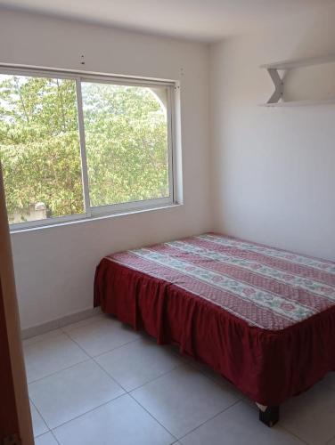 a bedroom with a bed and a window at Vacation home with lake access and pool in Tequesquitengo