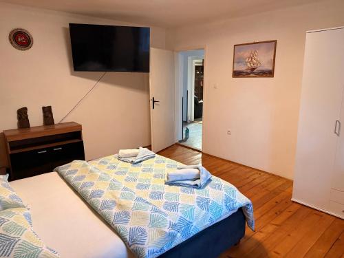 a bedroom with a bed and a flat screen tv at Apartment Ivana in Murter