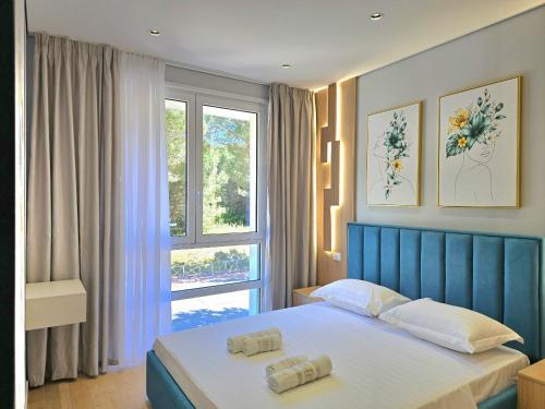 a bedroom with a bed with two towels on it at White Shell Apartments in Lalzit Bay