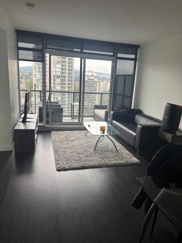 a living room with a couch and a table at Brentwood Retreat in Burnaby