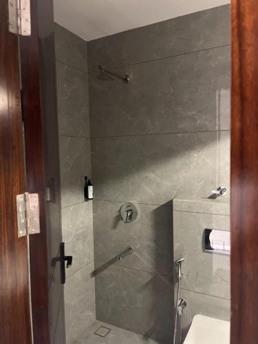 a bathroom with a shower with a toilet and a sink at Hotel route 54 in Bathinda