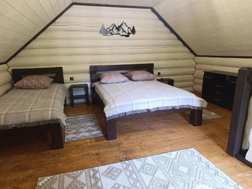 a room with two beds in a attic at Тихий світанок in Synevyrsʼka Polyana