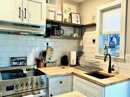 a kitchen with a sink and a stove at Charming 1 bedbath Suite in waterfront Cottage in Somers