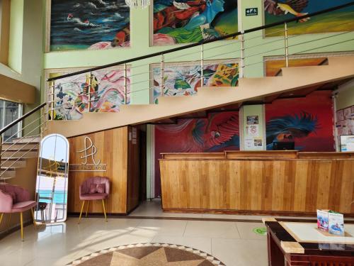 a lobby with a large painting on the wall at Park Place Hotel in Siguatepeque
