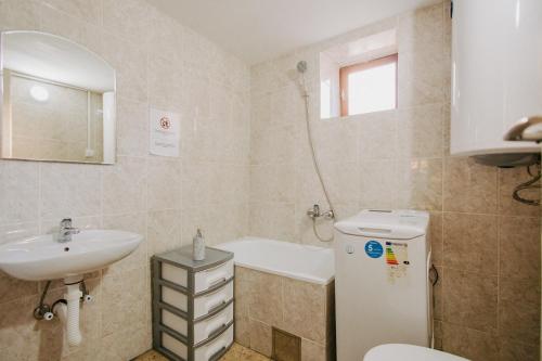 a bathroom with a sink and a tub and a toilet at Kuća Mitića in Pirot