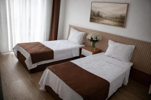 a hotel room with two beds and a window at Kemer Suit Residence in Kemer