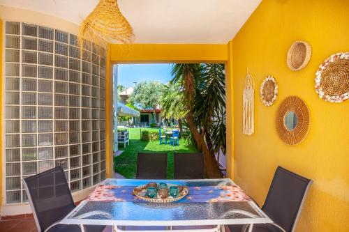 a dining room with a table with a bowl of fruit at Villa Portoblue Pearl in Pefkochori