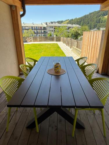 a blue picnic table with a cake on it on a deck at Villa Vita - GLORIA in Slovenj Gradec