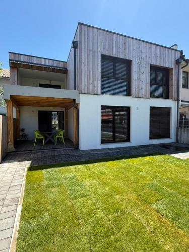 a modern house with a lawn in front of it at Villa Vita - GLORIA in Slovenj Gradec