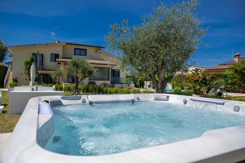 a hot tub in front of a house at Villa Karina - Luxury Suite, Jacuzzi Pool & Garden Ostia Rome in Lido di Ostia