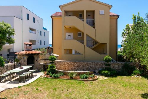 a house with a garden and a building at Apartments Lea in Mandre