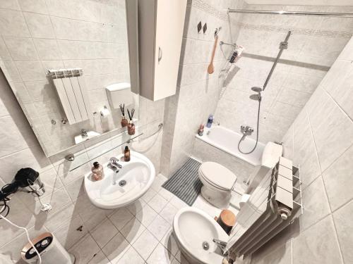 a white bathroom with a toilet and a sink at Casa di Minù in Empoli