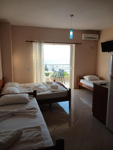 a hotel room with two beds and a view of the ocean at RAHI Rooms in Gjilek