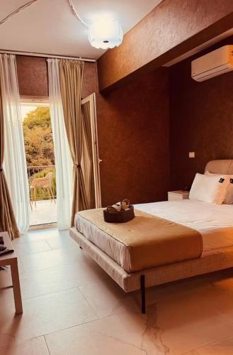 a bedroom with a large bed and a large window at Mostoliva Sea View Studios in Pržno