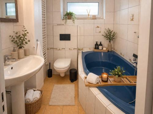 a bathroom with a tub and a toilet and a sink at A+R Pension in Pilsen