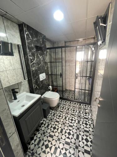 a bathroom with a shower and a toilet and a sink at Duplex Villa with Panoramic Sea View in Gokceada Town