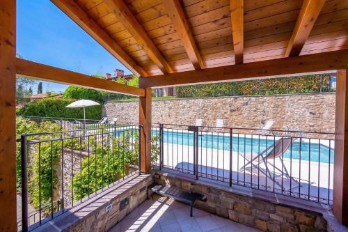 a balcony with a view of a swimming pool at Como Lake Modern Apartament Ulivi in Mezzegra
