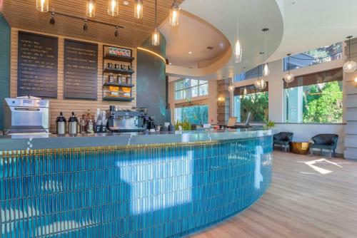 a swimming pool with a bar in a restaurant at Sandman Signature Surrey-Guildford Suites in Surrey