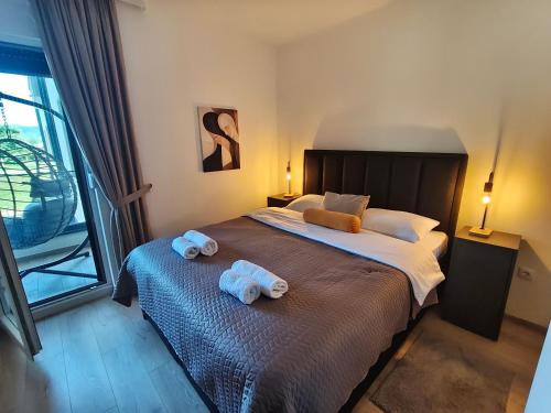 a bedroom with a large bed with towels on it at Nota in Veliko Gradište