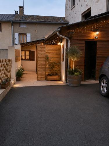 a house with a garage with a car parked next to it at Maisonnette Cosy in La Llagonne