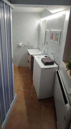 a white bathroom with a sink and a counter at Mazzmarill in Pizzoferrato