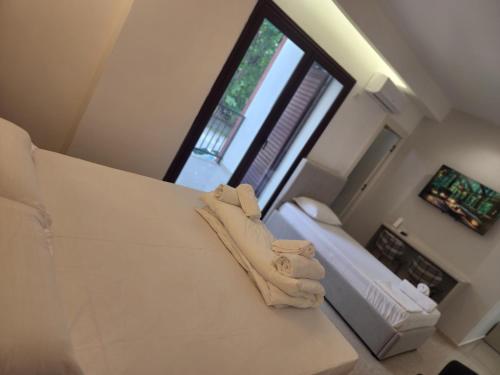 a bedroom with a bed and a large window at Eden Rooms in Vlorë