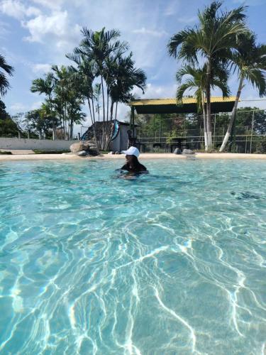 a person in the water in a swimming pool at El Rincon De Lupe in San Carlos