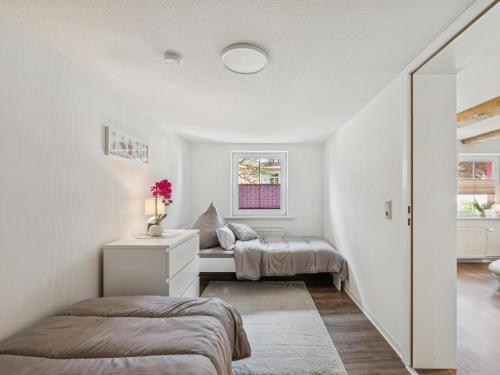 a bedroom with two beds and a window at Modern apartments harz I in Elbingerode
