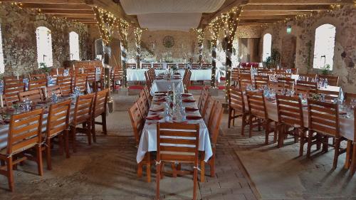 a large dining room with tables and chairs in a building at Bläsinge Gård Kullabygden in Jonstorp