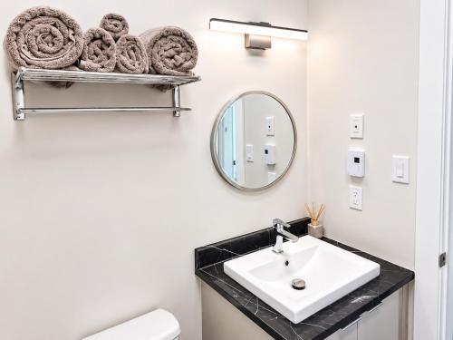 a bathroom with a sink and a mirror at Quiet Haven - One-Bedroom Suite in Riverview