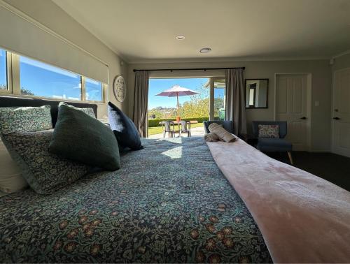 a bedroom with a large bed with a view of a patio at Studio Haven on Fort in Cambridge