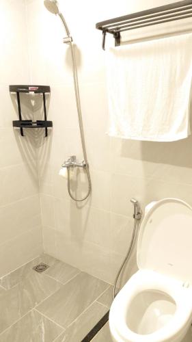 a bathroom with a shower and a toilet at Alex Vinhomes Grand in Gò Công