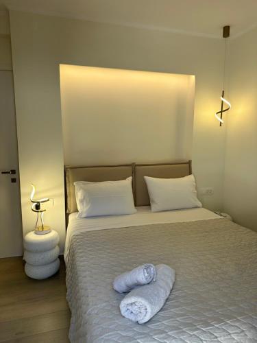 a bedroom with a bed with two towels on it at K&L Luxury Suite 2 in Parga