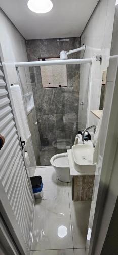 a small bathroom with a sink and a shower at RG Kitnet05 in Curitiba