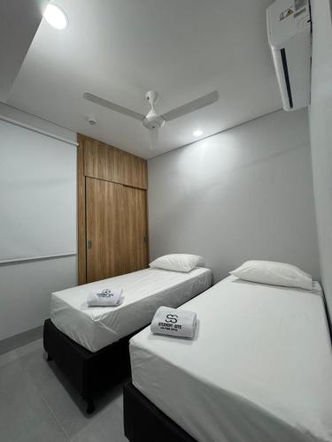 a room with two beds and a window in it at Student Site - Coliving Hotel in Montería