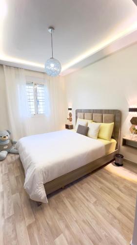 a bedroom with a large bed in a room at Perle de Tamaris Appartement Moderne, Bien Équipé, Piscine pour Enfants Parking in Casablanca