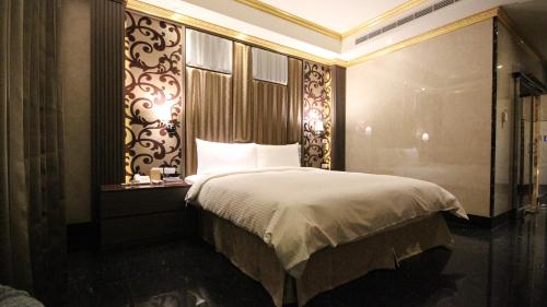 a bedroom with a bed in a room with a window at Gold Sand Hotel in Hsinchu City