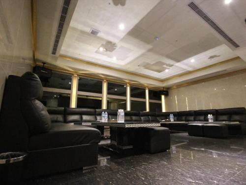 a room with couches and a table with bottles of water at Gold Sand Hotel in Hsinchu City
