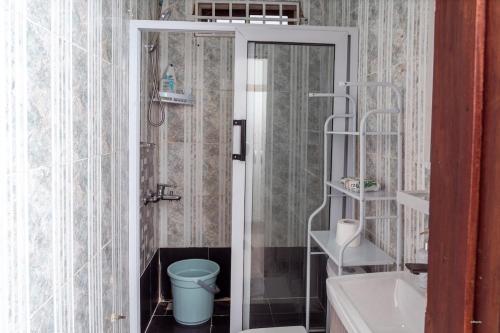 a bathroom with a toilet and a sink at Kumbaya Apartments in Achimota