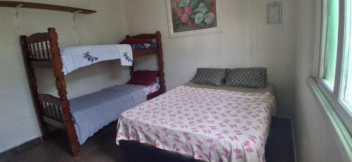 a bedroom with two bunk beds and a bed at Loft Praia do Sonho in Itanhaém