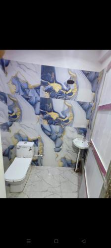 a bathroom with a sink and a toilet in a room at Agrasen Homestay in Prayagraj