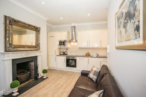 a living room with a couch and a fireplace at Grand Canal District Apartments in Dublin