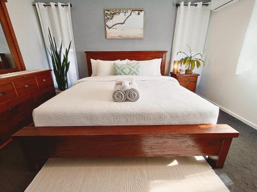 a bedroom with a large bed with two towels on it at Executive King Suite - Ensuite in Holmview