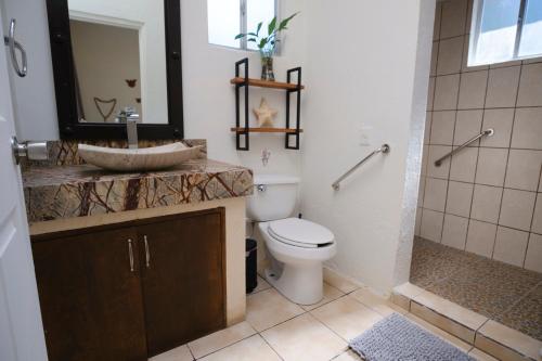 a bathroom with a sink and a toilet and a shower at Casa Los Agapandos in Valle de Bravo